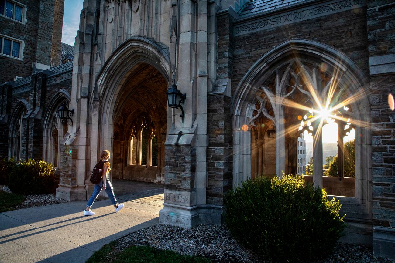 Students walk through campus in the early evening.